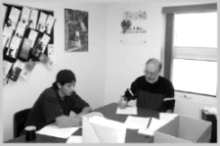 Two adult males working at a table