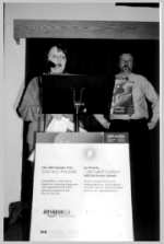 Two adults, one at a speaker's podium