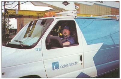 picture of a cable technician sitting in the company van