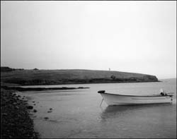 photo of a boat anchored near a shore