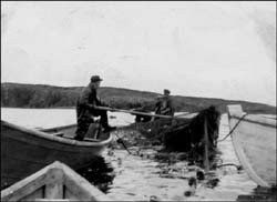 photo of two men in two boats