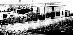 photo of building and a ship at a wharf