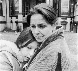 Child being hugged by her mother