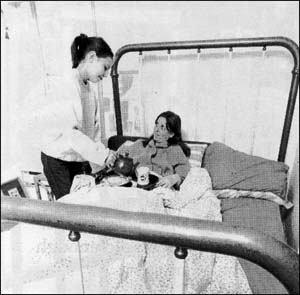 Girl serving her mother food in bed