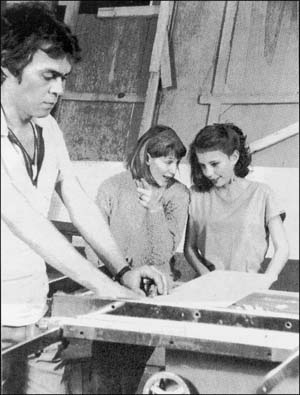 Two girls and a guy at a workshop
