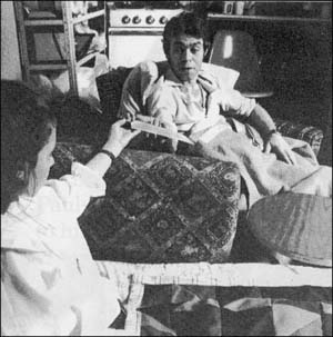 Woman holding knife out to man