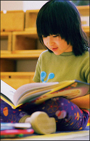 Little girl reading a book