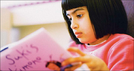 little girl reading a book