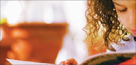 little girl reading a book