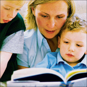 Mother reading a book to her childs