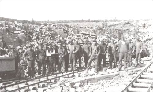 photo of a group of men standing by railway tracks