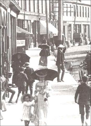 photo of several people walking on a sidewalk