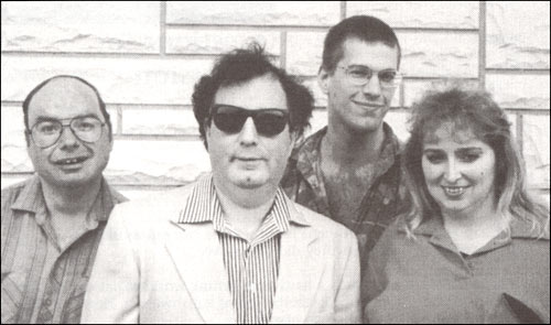 photo of three men and a woman