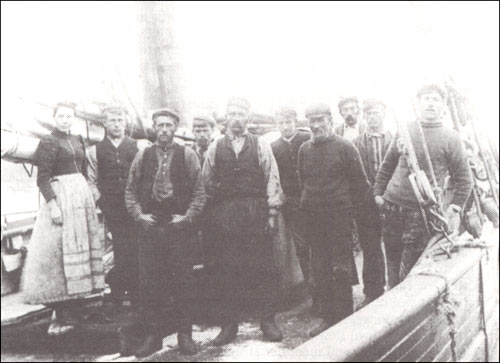 photo of a woman and several men on the deck of a fishing schooner