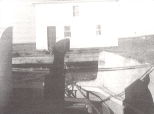 photo of a house being towed behind a boat