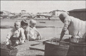 photo of woman and three small children