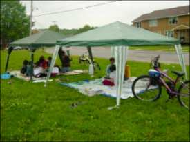 People under two tent canopies