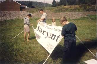 People erecting a Storytent sign
