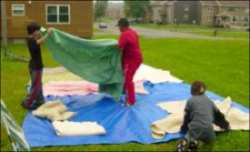 Adults setting up tents
