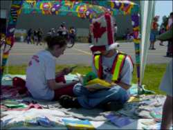 Two people sitting under a tent canopy