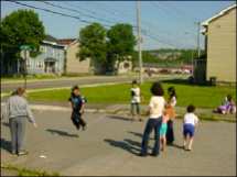 Adults helping children to skip