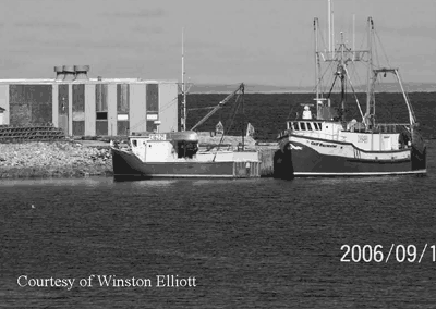 Two boats tied to the Brig Bay wharf