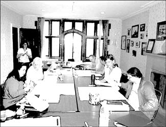 students and tutors at work aound a large table