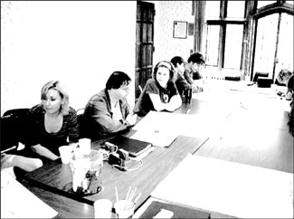 students and tutors at work at a table