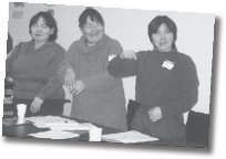 Three women at a welcome desk