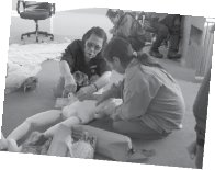 couple of inuit building a doll