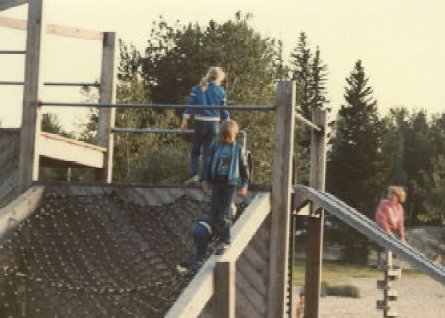 graphic of a photo of three children playing on a jungle gym