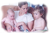 photo of a mother reading with a baby and a toddler