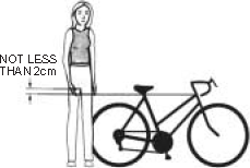 Woman standing behind a bicycle