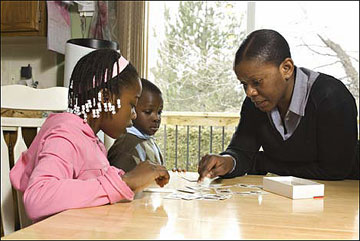 A mother playing cards with her children