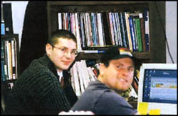 A picture of 2 guys near a computer