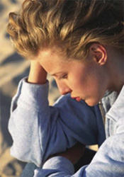 woman leaning her head on her hand