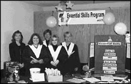 photo of five women standing in a booth