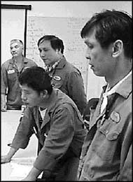 photo of four people standing around a table