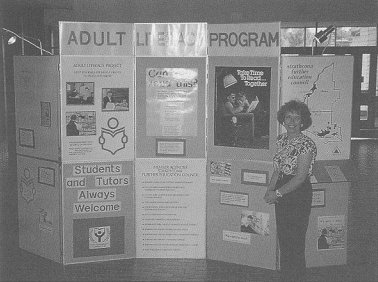 Marnee standing beside her display