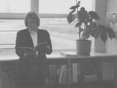 Carolyn reading by the window