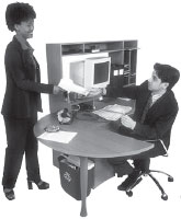 A woman and a man at a desk.