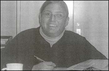 photo of an adult seated and writing