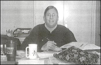 photo of an adult sitting at a table