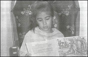 photo of a young girl reading a book