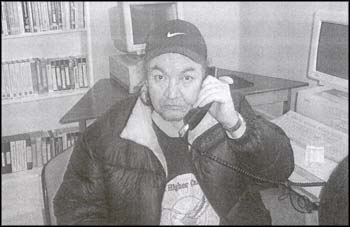 photo of a man talking on a telephone